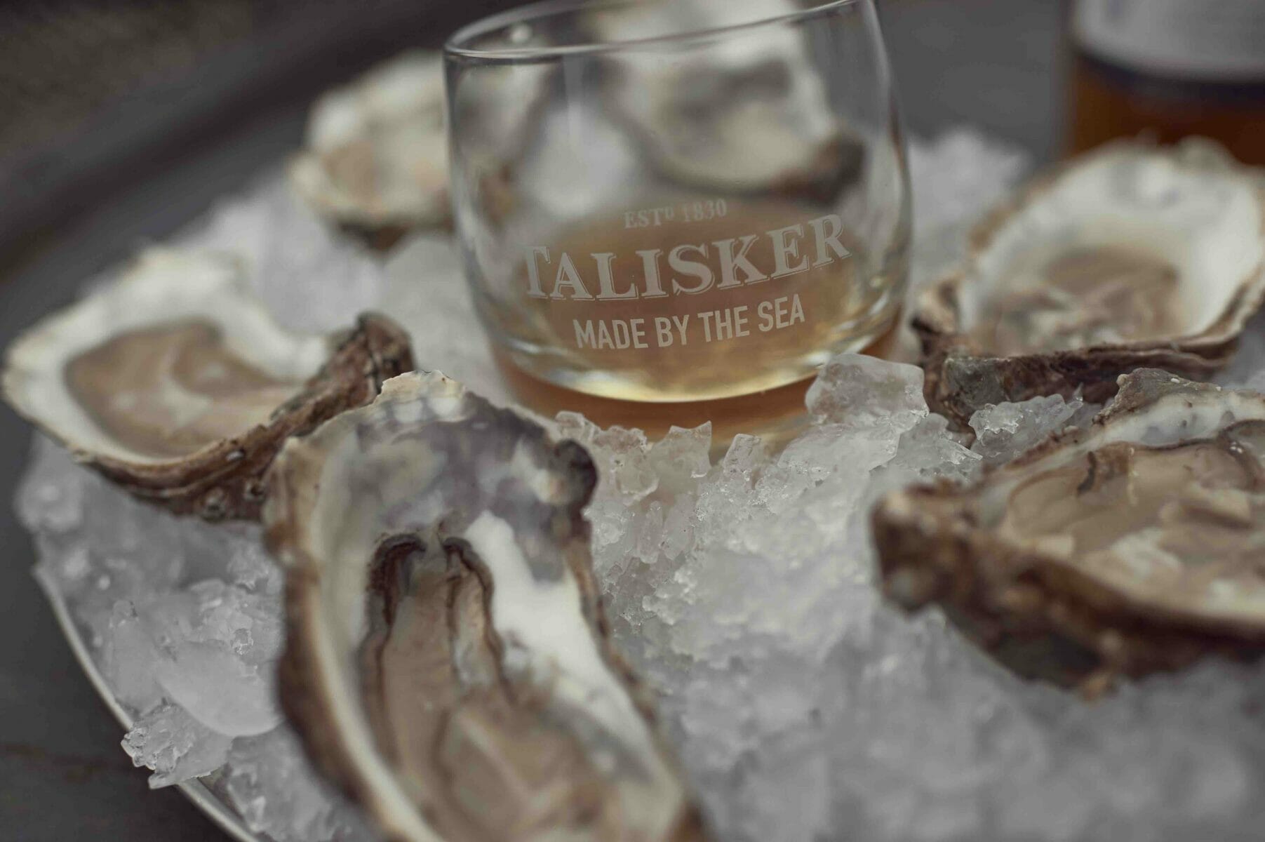 bicchiere con whisky ed ostriche