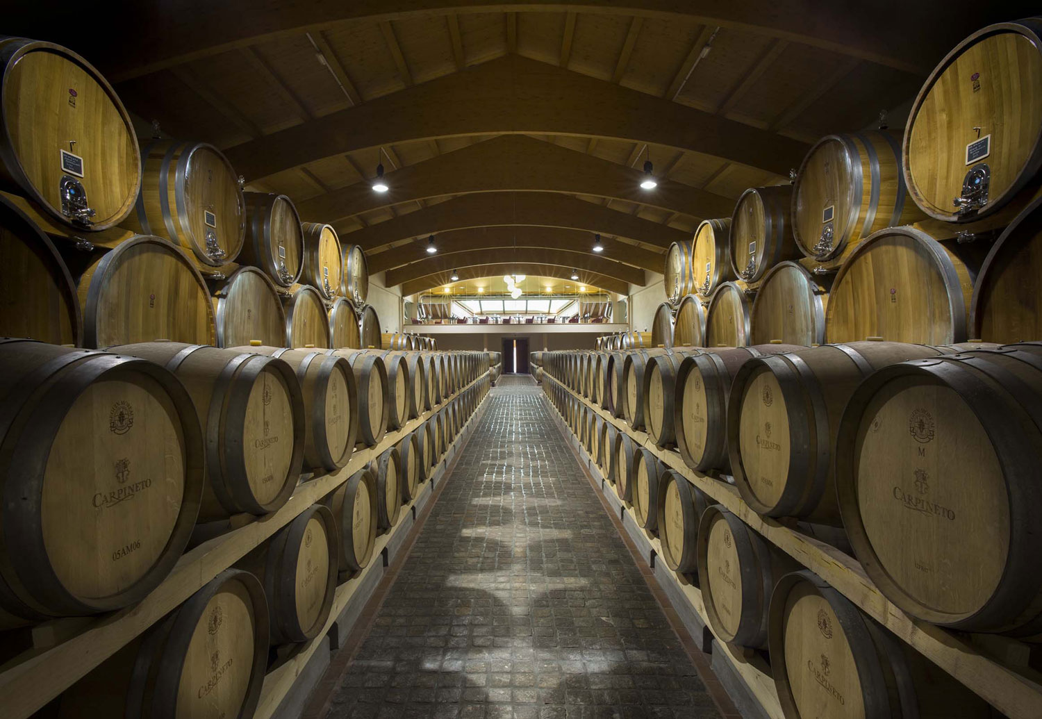 San Valentino in Toscana nella barricaia di Montepulciano, grandi botti di affinamento Carpineto protagoniste dell’esperienza enoturistica.
